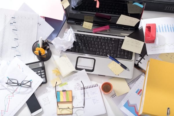 Messy and cluttered office desk
